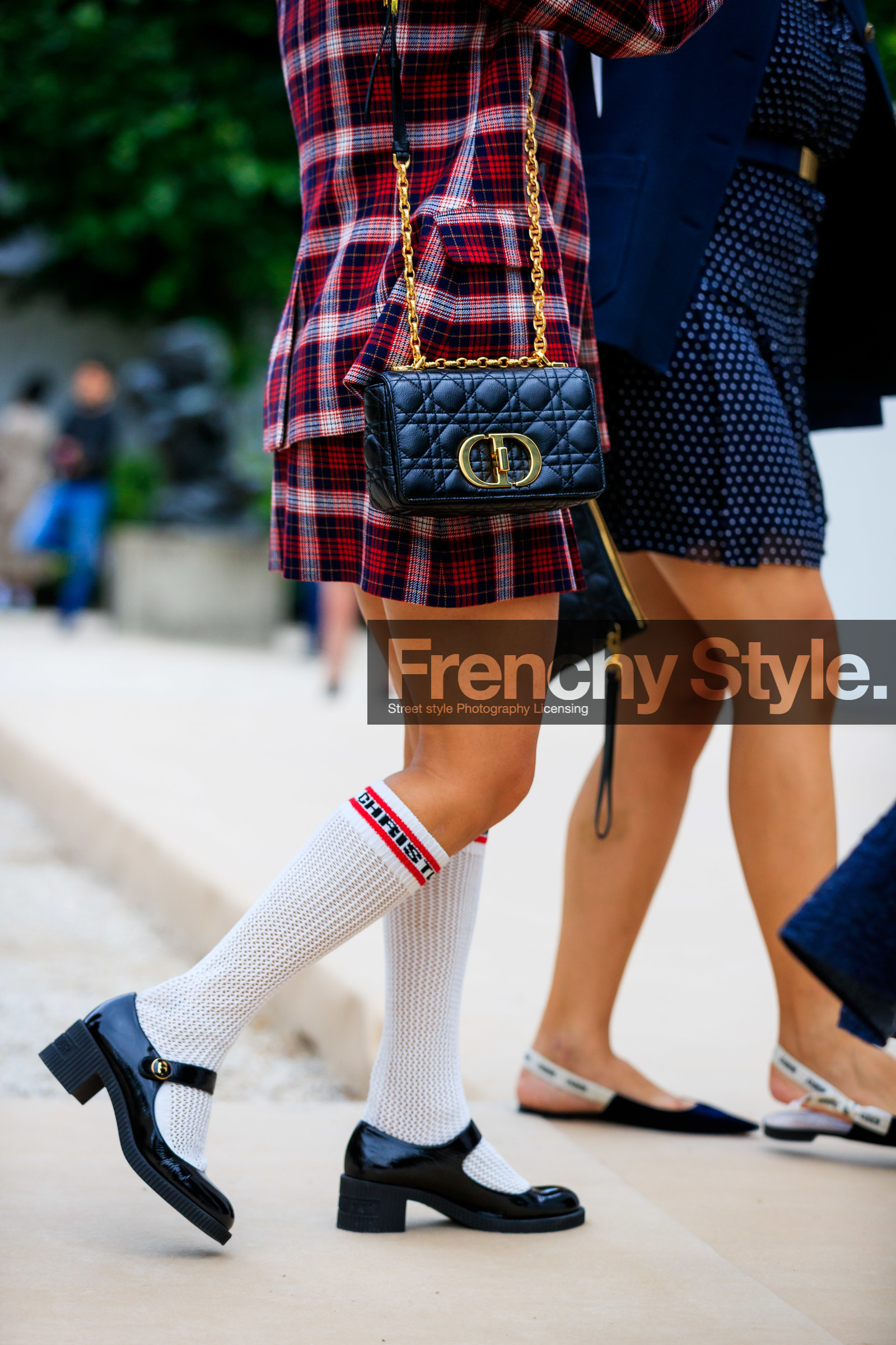 caro dior bag, school girl look, checked jacket, checked skirt, checked suits, red jacket, red skirt, red suits, mini skirt, dior bag, dior jacket, dior skirt, dior total look, dior socks, dior shoes, black leather bag, quilted bag, chain strap bag, golden strap bag, shoulder bag, white socks, black shoes, varnished shoes, mary jane shoes, close up detail, bag detail, legs detail, shoes detail, Karen Wazen Bakhazi, fashion week, frenchystyle, FW, jonathan paciullo, street style, PFW, PARIS, AUTUMN WINTER 2021-2022, FALL WINTER 2021-2022, FW 21-22, vertical, atmosphere details, detail
