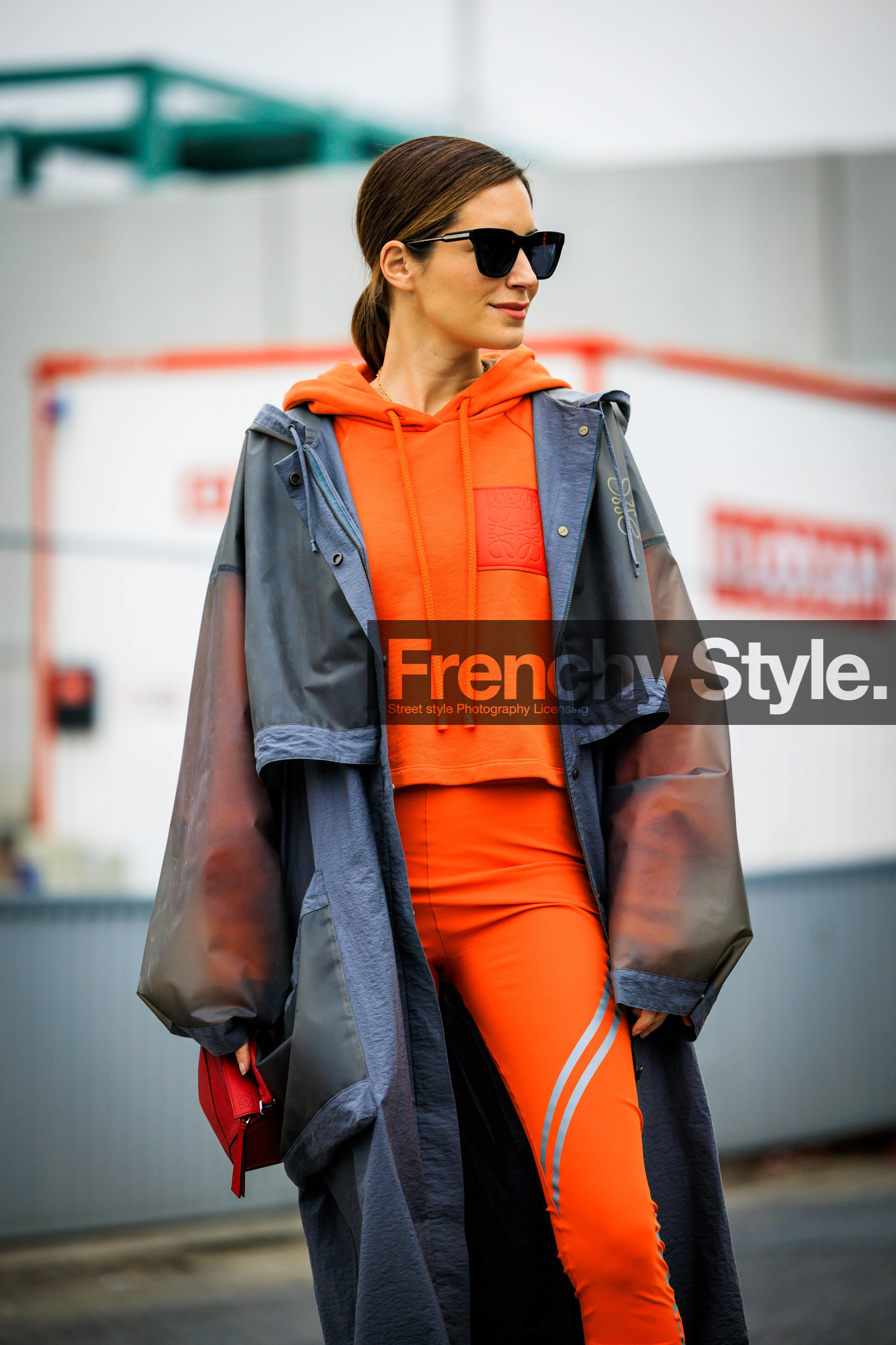 orange hoodie, rain coat, grey jacket, loewe coat, black sunglasses, orange leggings, red handbag, loewe handbag, gala gonzalez, street style, jonathan paciullo, FW, frenchystyle, fashion week, AUTUMN WINTER 2022-2023, FALL WINTER 2022_2023, FW 22-23, PFW, PARIS, vertical, detail