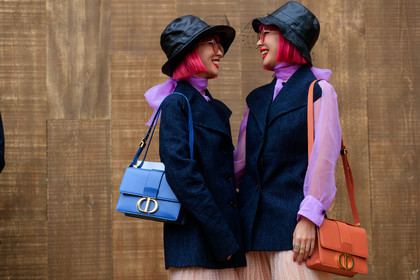 Ami and Aya Suzuki, pink hair, dyed hair, black hat, tulle hat, tulle details, pink sunglasses, square shape glasses, lilac blouse, lavalliere collar, dark grey jacket, sleeveless jacket, dior bag, dior skirt, orange leather bag, light blue leather bag, shoulder bag, nude skirt, long skirt, plumetis skirt, pleated skirt, prada boots, mini bag, laced boots, black leather boots, 30 montaigne bag, fashion week, frenchystyle, FW, jonathan paciullo, street style, SPRING SUMMER 2020, SS 20, PFW, PARIS, horizontal, atmosphere details, detail