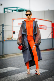 orange hoodie, rain coat, grey jacket, loewe coat, black sunglasses, orange leggings, red handbag, loewe handbag, black sandals, loewe shoes, loewe sandals, gala gonzalez, street style, jonathan paciullo, FW, frenchystyle, fashion week, AUTUMN WINTER 2022-2023, FALL WINTER 2022_2023, FW 22-23, PFW, PARIS, full length, vertical