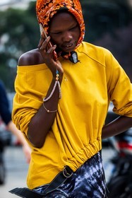black pants, color, facial mask, head scarf, orange scarf, pants, print, printed pants, printed scarf, scarf, tie and dye, top, yellow top, smartphone, fashion week, frenchystyle, FW, jonathan paciullo, street style, SPRING SUMMER 2022, SS 22, MFW, MILAN, vertical, atmosphere details