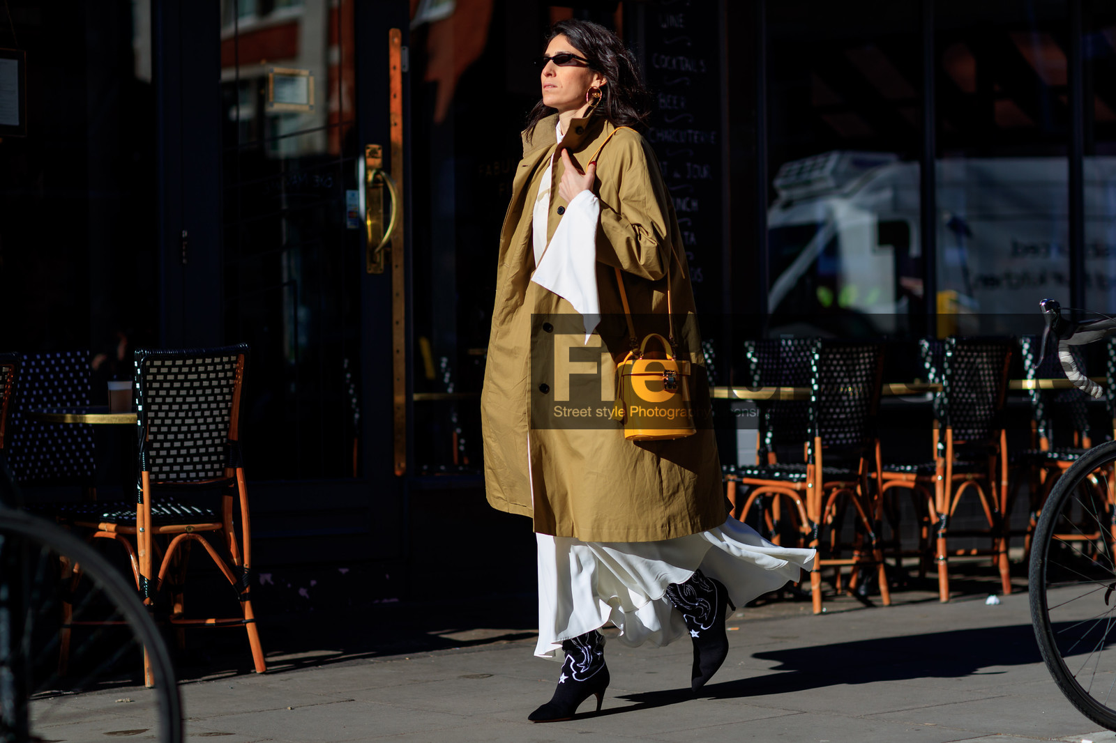 beige coat, black shoes, cowboy boots, high heels, leather bag, leather shoes, sunglasses, white dress, yellow bag, street style, jonathan paciullo, FW, frenchystyle, fashion week, LFW, LONDON, AUTUMN WINTER 2018-2019, AW 18-19, FALL WINTER 2018-2019, FW 18-19, horizontal, atmosphere details, full length, deborah reyner sebag