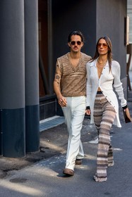 Alice Barbier, beige knit, beige pants, brown bag, brown clog, couple, duo, fluid pants, Jean-Sebastien Roques, knitted pants, leather bag, missoni look, orange sunglasses, printed pants, ribbed cardigan, sleveless knit, striped knit, sunglasses, white cardigan, white pants, v-neck knit, fashion week, frenchystyle, FW, jonathan paciullo, street style, MFW, MILAN, SPRING SUMMER 2022, SS 22, vertical, full length, menswear