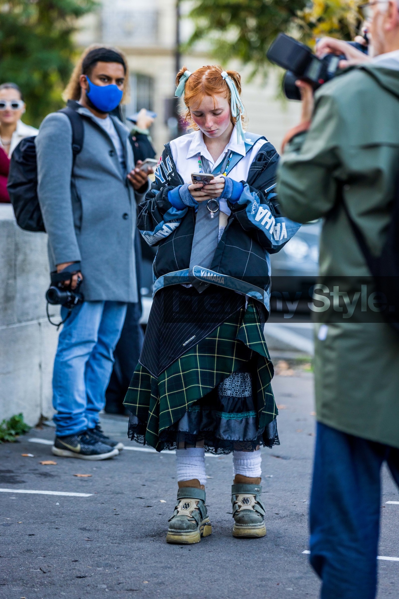 blue jacket, blue tie, boots, checked jacket, checked skirt, green skirt, jacket, khaki boots, patchwork, print, printed jacket, printed skirt, printed tie, ruggles, shirt, skirt, smartphone, sock, tartan skirt, tie, white shirt, fashion week, frenchystyle, FW, jonathan paciullo, street style, PFW, PARIS, SPRING SUMMER 2022, SS 22, vertical, atmosphere details