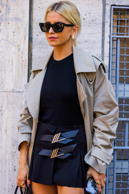 beige trenchcoat, black skirt, black top, Caroline Daur, prada skirt, skirt, sunglasses, trenchcoat, pleated skirt, mini skirt, fashion week, frenchystyle, FW, jonathan paciullo, street style, MFW, MILAN, SPRING SUMMER 2022, SS 22, vertical, atmosphere details, detail