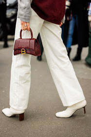 white trouser, flared pants, hourglass bag, balenciaga bag, leather bag, mini bag white boots, details, astrid boutrot, street style, jonathan paciullo, FW, frenchystyle, fashion week, AUTUMN WINTER 2022-2023, FALL WINTER 2022_2023, FW 22-23, PFW, PARIS, vertical, detail