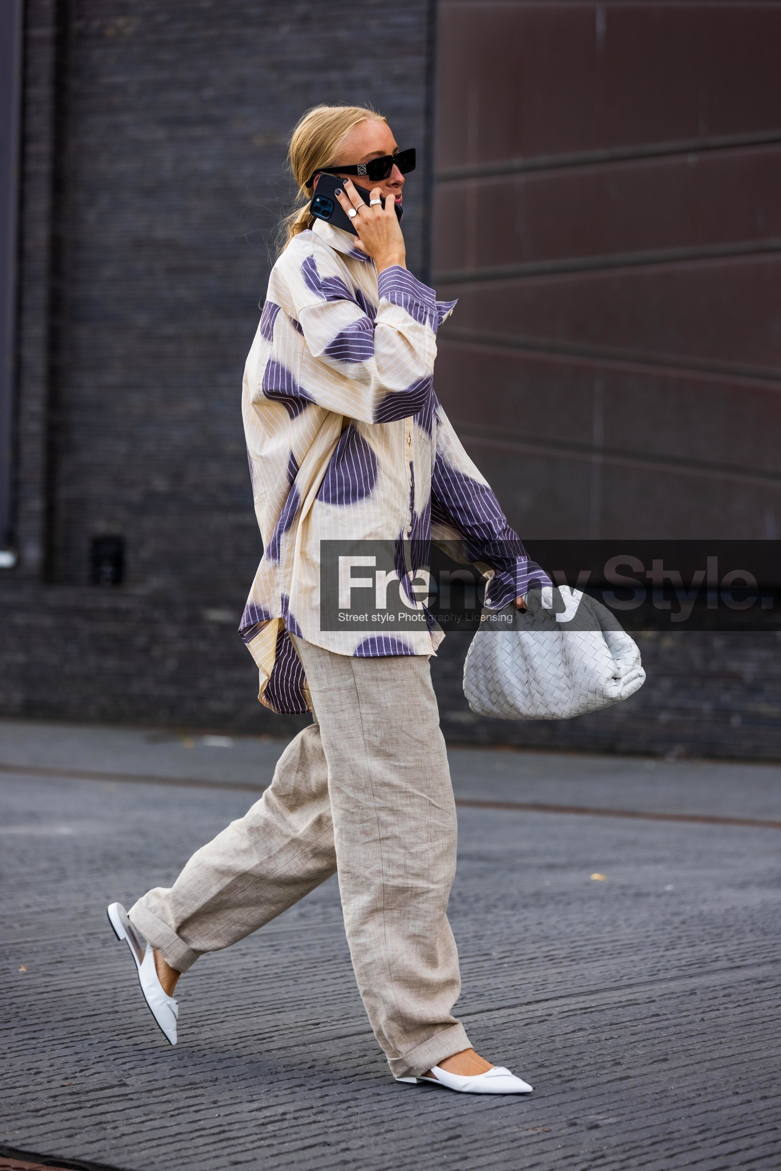 Ellen Claesson, iphone, white shirt, blue shirt, long shirt, striped shirt, tie and dye shirt, oversize shirt, polka dots shirt, white leather clutch, white leather shoes, white leather ballerina, sharp end shoes, sling back shoes, flat shoes, prada shoes, bottega veneta bag, light grey leather clutch, beige pants, loose pants, square shape glasses, loewe sunglasses, fashion week, frenchystyle, FW, jonathan paciullo, street style, SPRING SUMMER 2022, SS 22, COPENHAGEN, CPHFW, vertical, full length