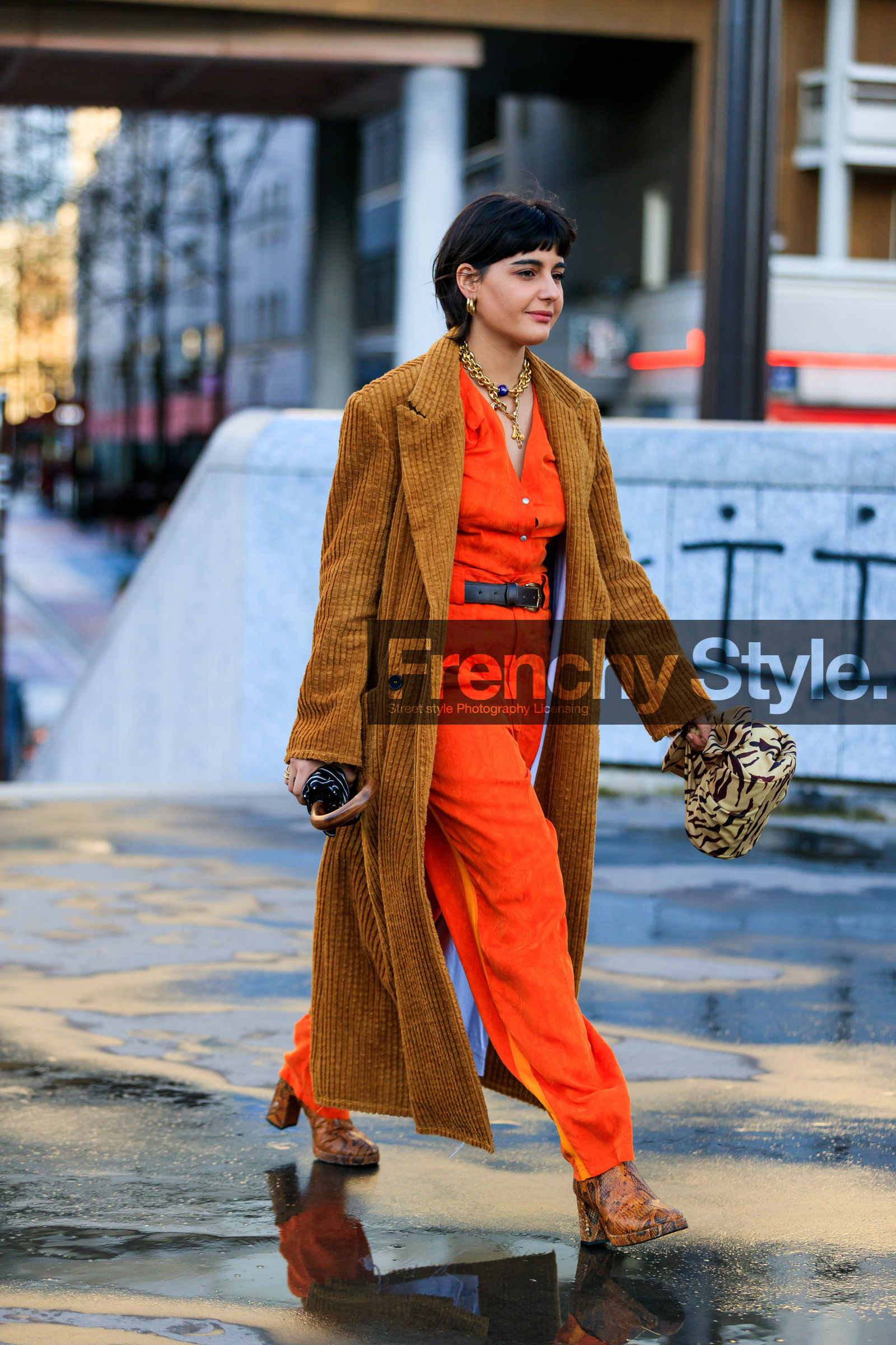 maria bernad, orange jumpsuit, low necked jumpsuit, button jumpsuits, belted jumpsuit, camel coat, velvet coat, corduroy coat, corduroy jacket, camel jacket, velvet jacket, long jacket, golden necklace, big chain necklace, charms necklace, multi necklace, flare jumpsuits, black leather belt, black bag, striped bag, beige bag, zebra bag, hand bag, satin bag, brown bag, knot details bag, round shape bag, golden earrings, hoop earrings, camel leather boots, animal skin boots, high heels boots, fashion week, frenchystyle, FW, jonathan paciullo, street style, PFW, PARIS, AUTUMN WINTER 2020-2021, FALL WINTER 2020-2021, FW 20-21, vertical, full length