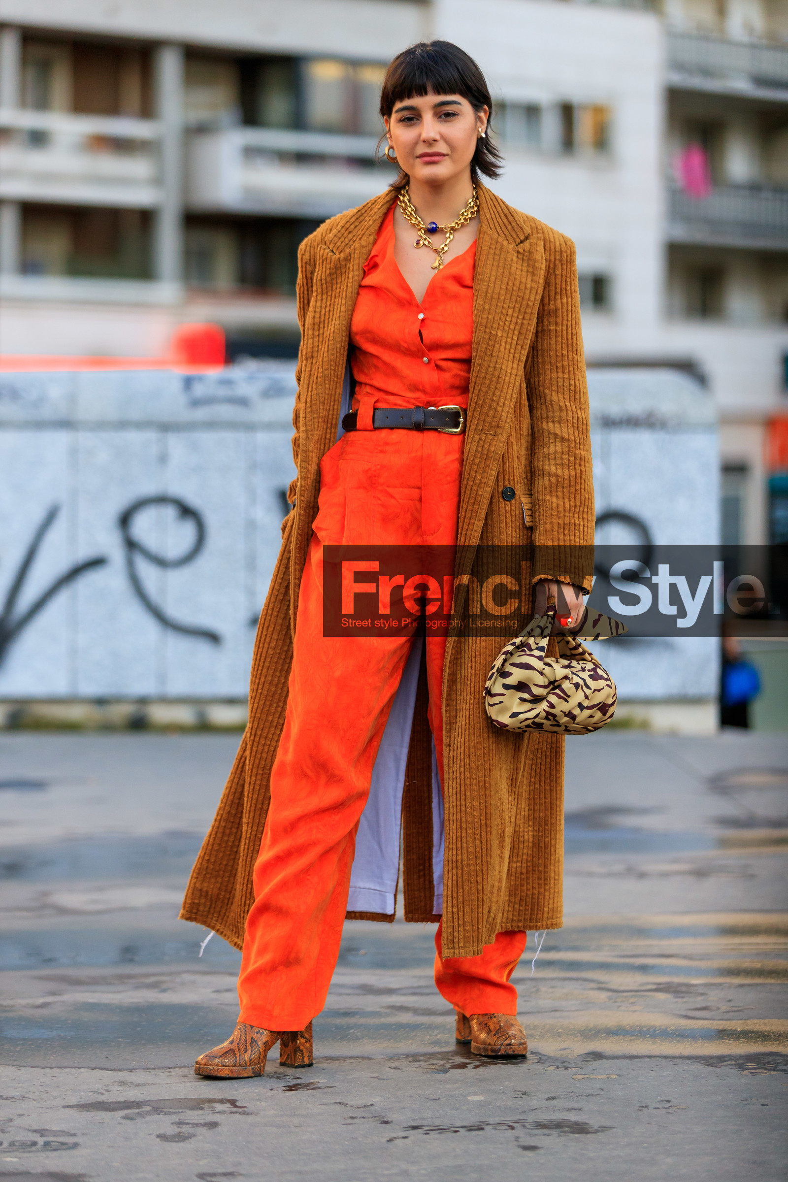 maria bernad, orange jumpsuit, low necked jumpsuit, button jumpsuits, belted jumpsuit, camel coat, velvet coat, corduroy coat, corduroy jacket, camel jacket, velvet jacket, long jacket, golden necklace, big chain necklace, charms necklace, multi necklace, flare jumpsuits, black leather belt, black bag, striped bag, beige bag, zebra bag, hand bag, satin bag, brown bag, knot details bag, round shape bag, golden earrings, hoop earrings, camel leather boots, animal skin boots, high heels boots, fashion week, frenchystyle, FW, jonathan paciullo, street style, PFW, PARIS, AUTUMN WINTER 2020-2021, FALL WINTER 2020-2021, FW 20-21, vertical, full length