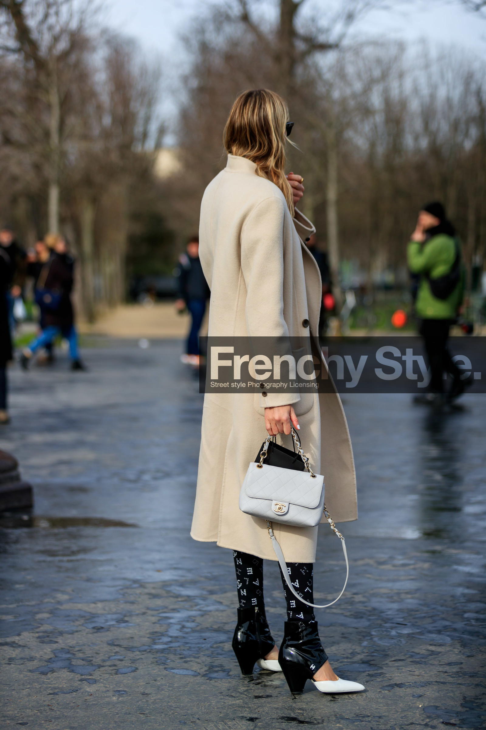 camille charriere, light beige coat, white leather bag, quilted bag, black pants, black polish boots, white polish boots, bicolor boots, logo printed pants, tight pants, strassed pants, low boots, kitten heels boots, openwork boots, chanel bag, chanel boots, chanel pants, hand bag, back details, bag detail, fashion week, frenchystyle, FW, jonathan paciullo, street style, PFW, PARIS, vertical, full length