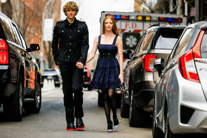 black full look, black buttoned drill military jacket, black straight cut pants, bottega veneta black leather boots, menswear, dark blue and black mini ruffled dress, black stockings, white printed stilletos, ginger hair, larsen thompson, fashion week, frenchystyle, FW, jonathan paciullo, street style, NYFW, NEW YORK, AUTUMN WINTER 2022-2023, FALL WINTER 2022_2023, FW 22-23, atmosphere details, horizontal, full length