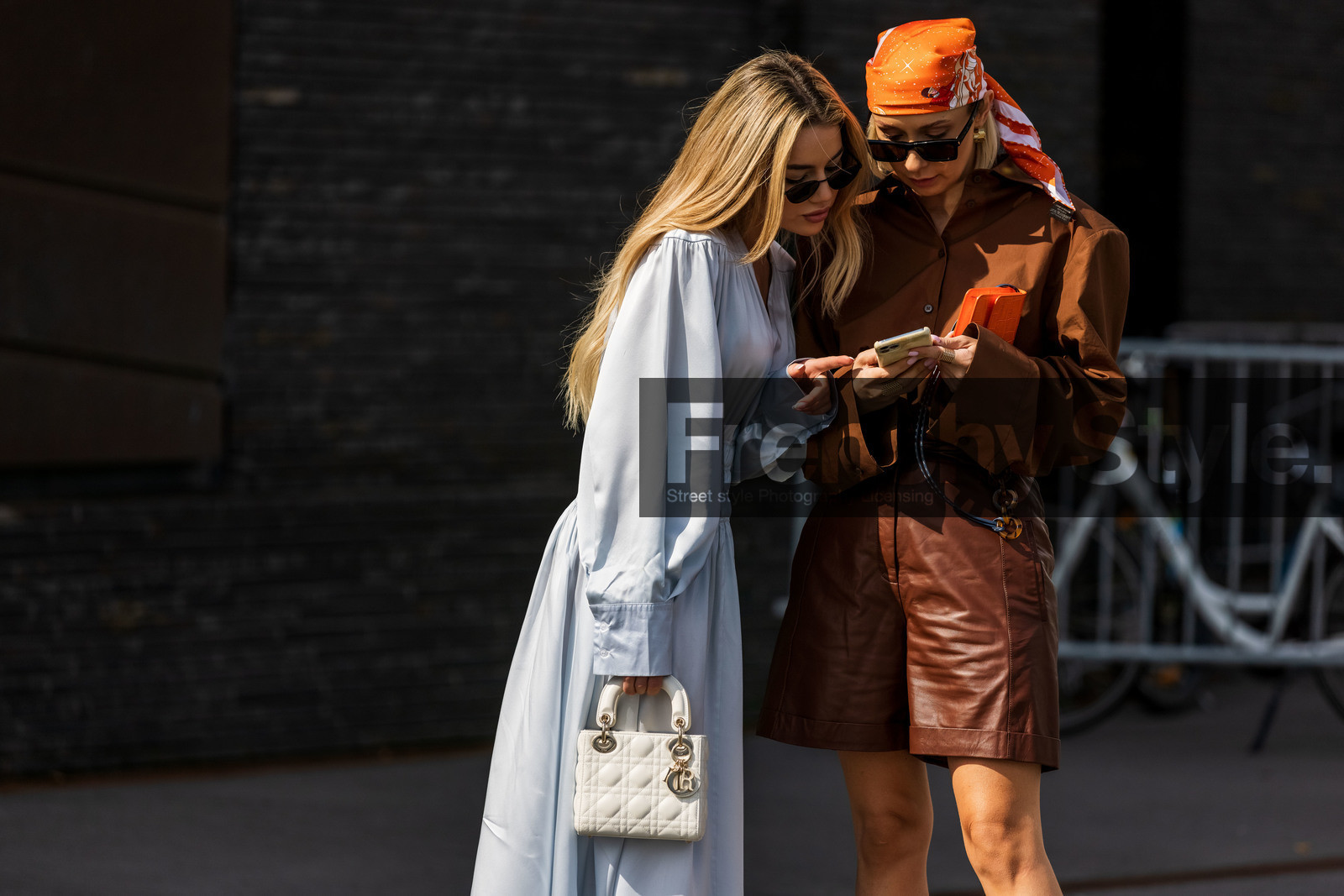 Justyna Czerniak, Karolina Wojcik, silk dress, satin dress, white dress, light blue dress, long dress, long sleeves dress, white leather bag, quilted bag, hand bag, dior bag, lady dior bag, silk scarf, orange scarf, hair details, hair scarf, brown shirt, brown shorts, brown total look, brown bermuda shorts, brown leather bermuda shorts, brown leather shorts, printed scarf, fashion week, frenchystyle, FW, jonathan paciullo, street style, SPRING SUMMER 2022, SS 22, COPENHAGEN, CPHFW, atmosphere details, horizontal