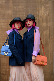 Ami and Aya Suzuki, pink hair, dyed hair, black hat, tulle hat, tulle details, pink sunglasses, square shape glasses, lilac blouse, lavalliere collar, dark grey jacket, sleeveless jacket, dior bag, dior skirt, orange leather bag, light blue leather bag, shoulder bag, nude skirt, long skirt, plumetis skirt, pleated skirt, prada boots, mini bag, laced boots, black leather boots, 30 montaigne bag, fashion week, frenchystyle, FW, jonathan paciullo, street style, SPRING SUMMER 2020, SS 20, PFW, PARIS, vertical, atmosphere details, detail