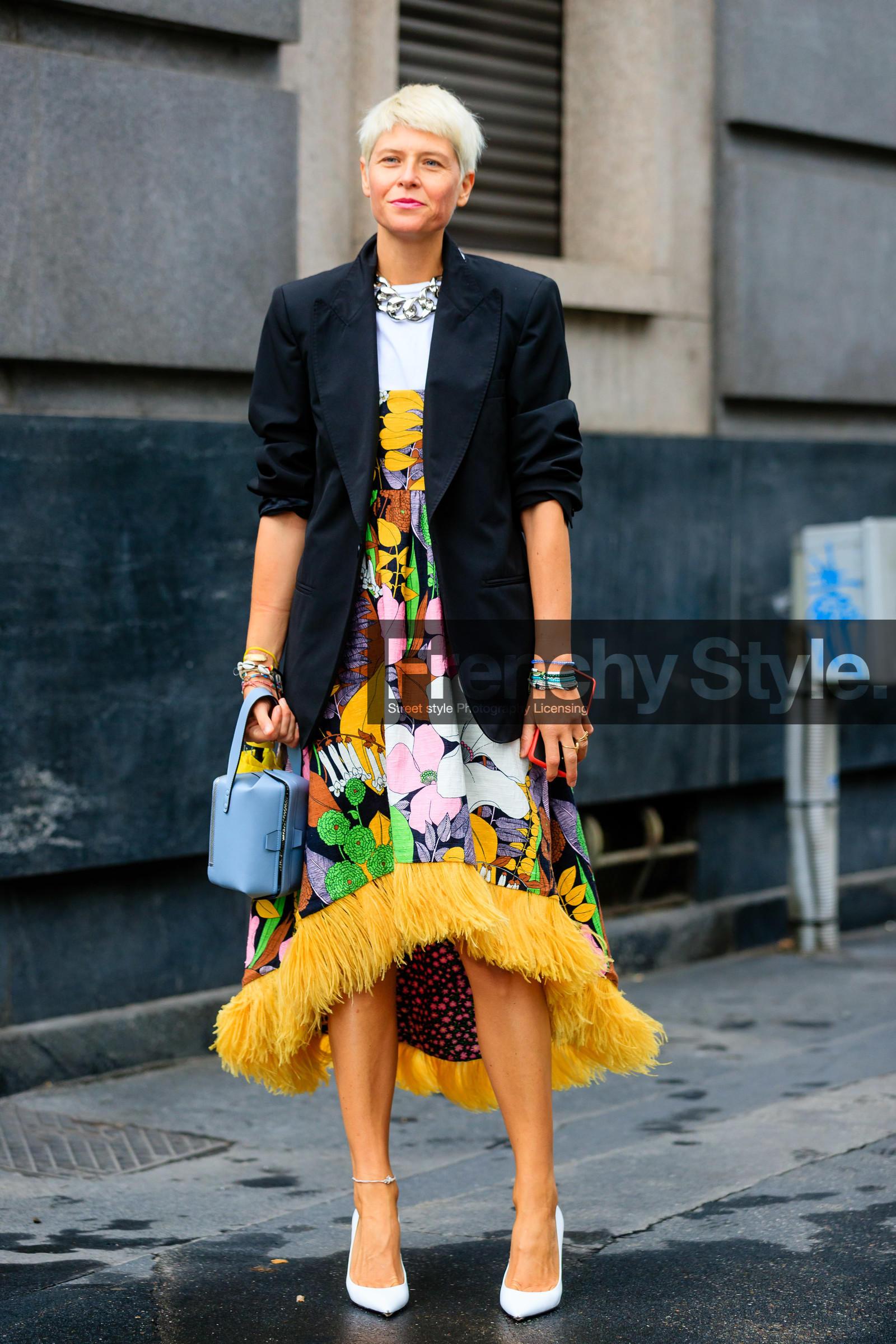 black jacket, oversize jacket, white t-shirt, white leather pumps, floral printed dress, strapless dress, feather details, feather details dress, asymetrical dress, yellow dress, vintage printed dress, 60's look, multicolor dress, silvered necklace, big chain necklace, light blue leather bag, mini bag, hand bag, pearl bracelet, shell bracelet, lucky charm bracelet, multi bracelet, elisa nalin, street style, jonathan paciullo, FW, frenchystyle, fashion week, MFW, MILAN, SPRING SUMMER 2021, SS 21, vertical, full length