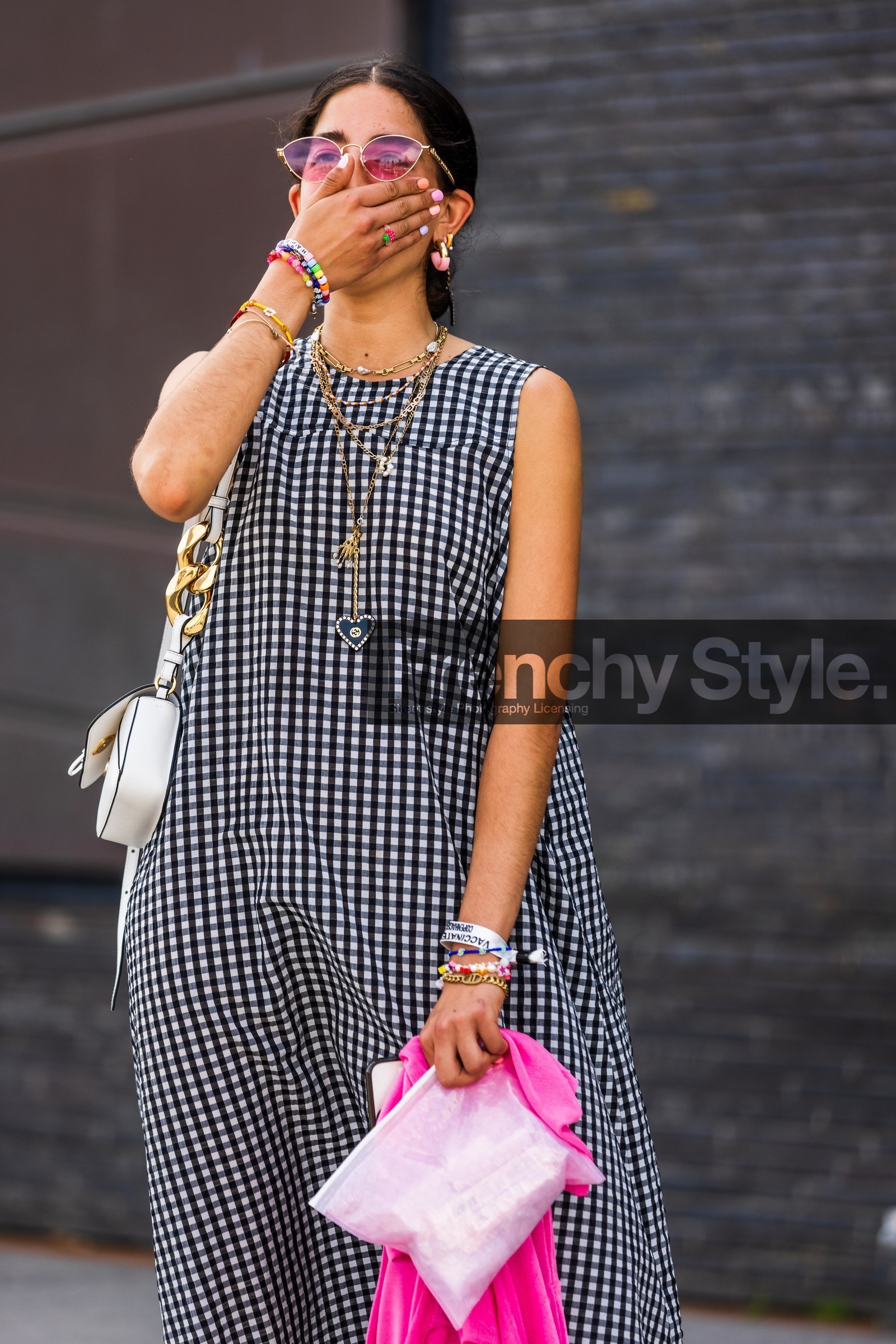 Selma Kaci, light pink clutch, sheer clutch, glossier clutch, dior bracelet, big chain bracelet, golden bracelet, golden chain bracelet, initials bracelet, pearl bracelet, multicolor bracelet, lucky charm bracelet, multi bracelet, vichy printed dress, black dress, white dress, bicolor dress, checked dress, sleeveless dress, loose dress, long dress, golden necklace, long necklace, multi necklace, charms necklace, gucci necklace, heart shape necklace, multi earrings, pink earrings, orange earrings, hoop earrings, letters necklace, pearl necklace, pink sunglasses, golden frame sunglasses, nail art, gucci sunglasses, fashion week, frenchystyle, FW, jonathan paciullo, street style, SPRING SUMMER 2022, SS 22, COPENHAGEN, CPHFW, vertical, atmosphere details