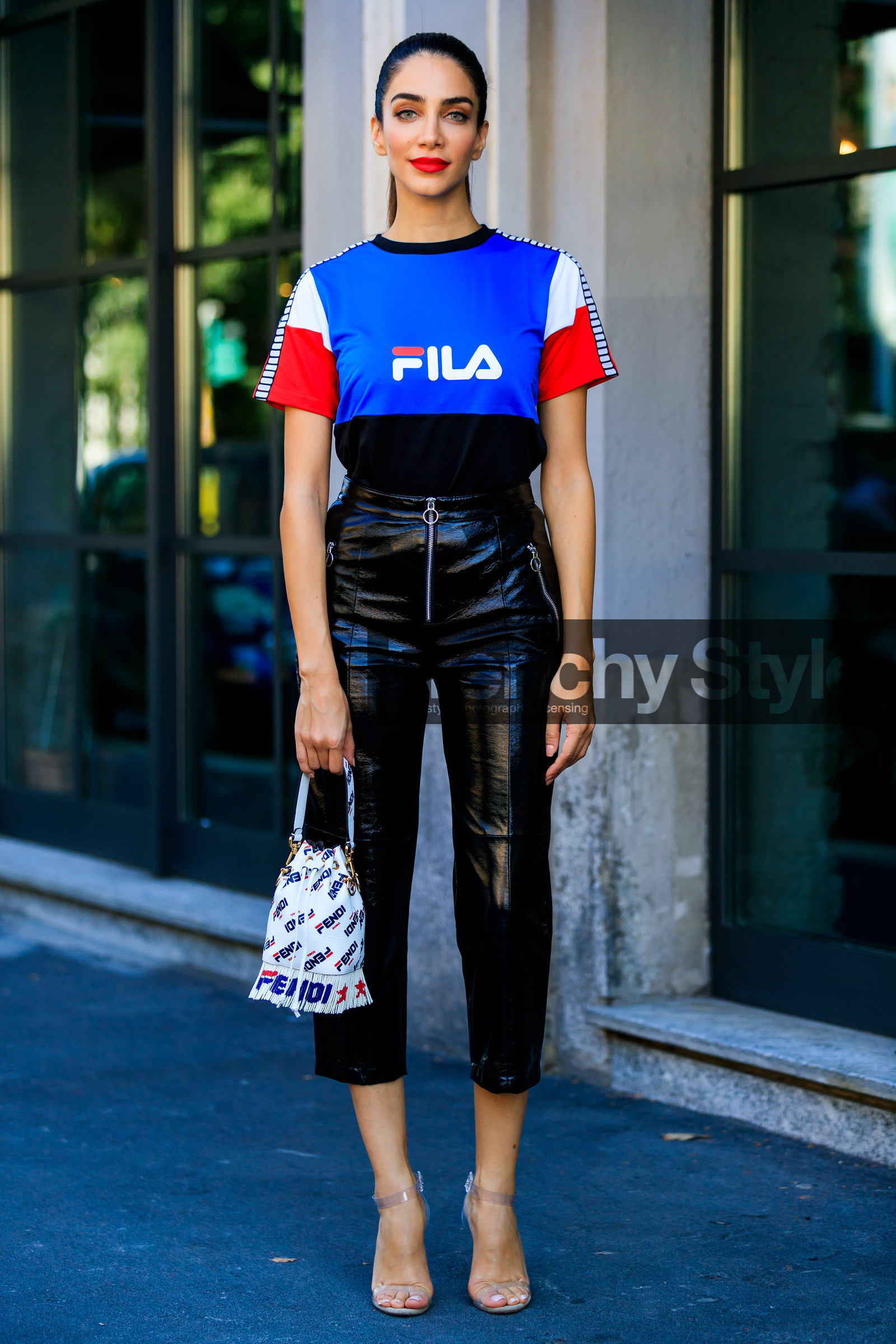 black pants, blue t shirt, crop top, fendi, fila, fringes, graphic bag, graphic top, high heels, jessica kahawaty, leather bag, leather pants, leather shoes, monogram, printed bag, printed t shirt, red lips, transparent shoes, trousers, white bag, street style, jonathan paciullo, FW, frenchystyle, fashion week, MFW, MILAN, SPRING SUMMER 2019, SS 19, vertical, full length