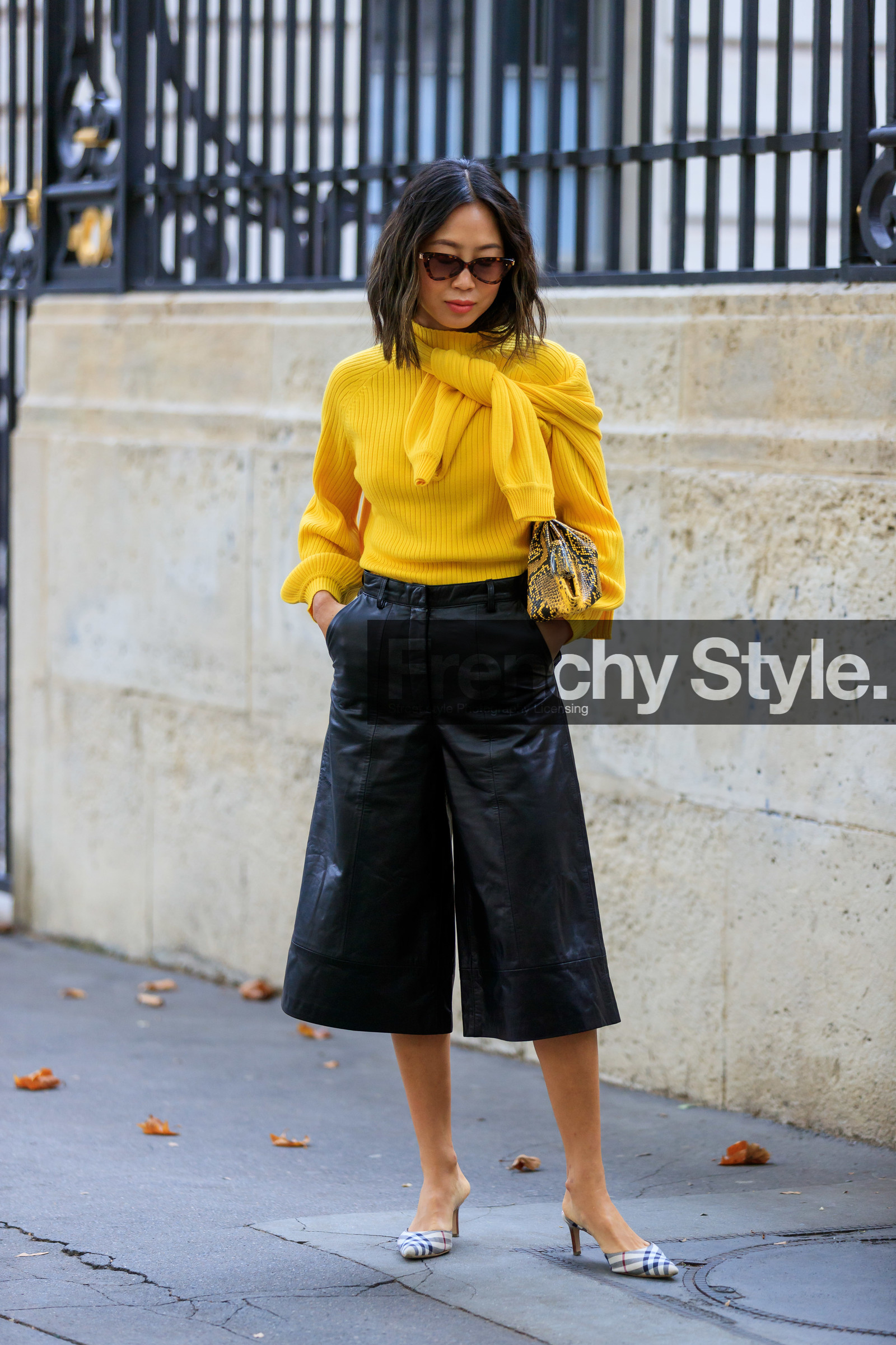 aimee song, yellow pullover, turtleneck pullover, bottega veneta bag, yellow leather bag, animal skin clutch, black leather bermuda shorts, checked slipers, kitten heels slippers, light beige slippers, burberry shoes, fashion week, frenchystyle, FW, jonathan paciullo, street style, SPRING SUMMER 2020, SS 20, PFW, PARIS, vertical, full length