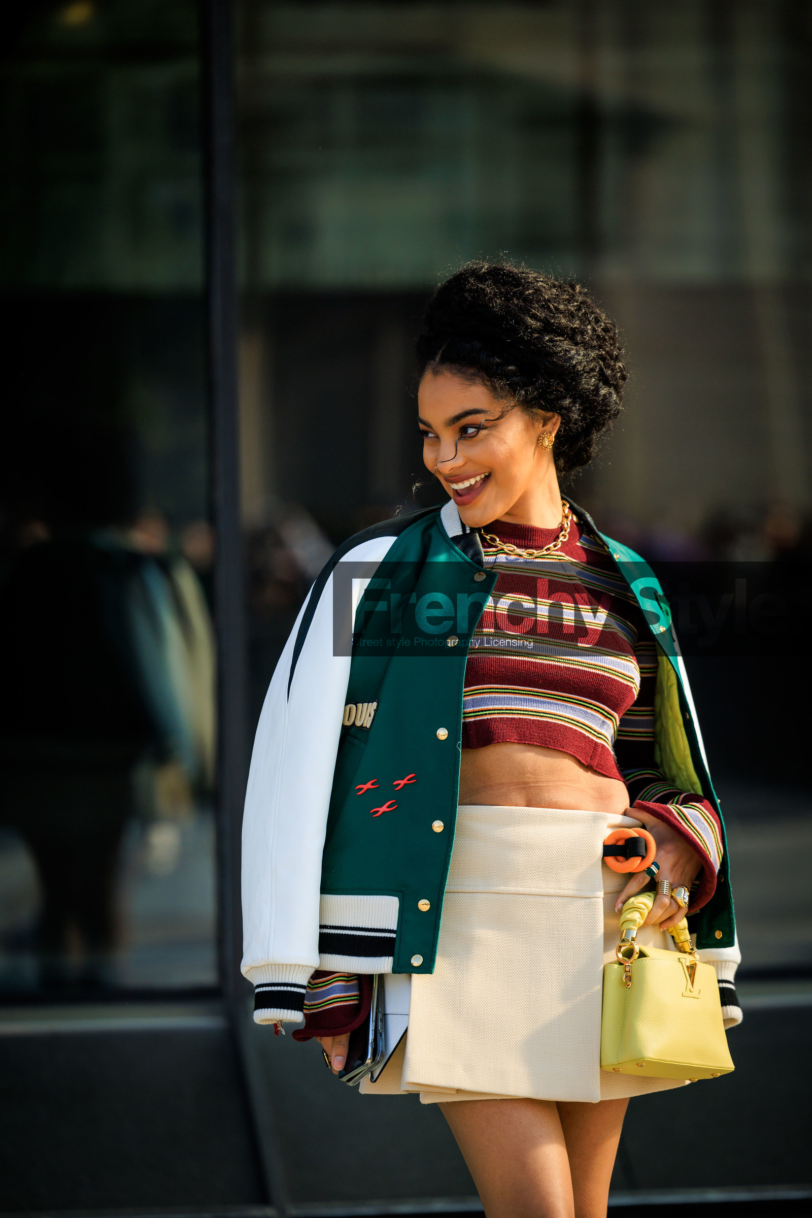 louis vuitton, baseball jacket, green jacket, striped top, knitted top, burgundy top, multicolor top, mini skirt, beige skirt, yellow handbag, louis vuitton bag, mini, bag, golden chain, afro hair, sharon alexie, street style, jonathan paciullo, FW, frenchystyle, fashion week, AUTUMN WINTER 2022-2023, FALL WINTER 2022_2023, FW 22-23, PFW, PARIS, vertical, detail