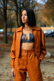 alexandra guerain, orange leather jacket, orange leather pants, orange total look, zipped jacket, black bra, cropped top, low necked top, black leather top, multi necklace, chain necklace, letters necklace, golden necklace, PARIS, PFW, SPRING SUMMER 2020, SS 20, fashion week, frenchystyle, FW, jonathan paciullo, street style, vertical, atmosphere details, detail