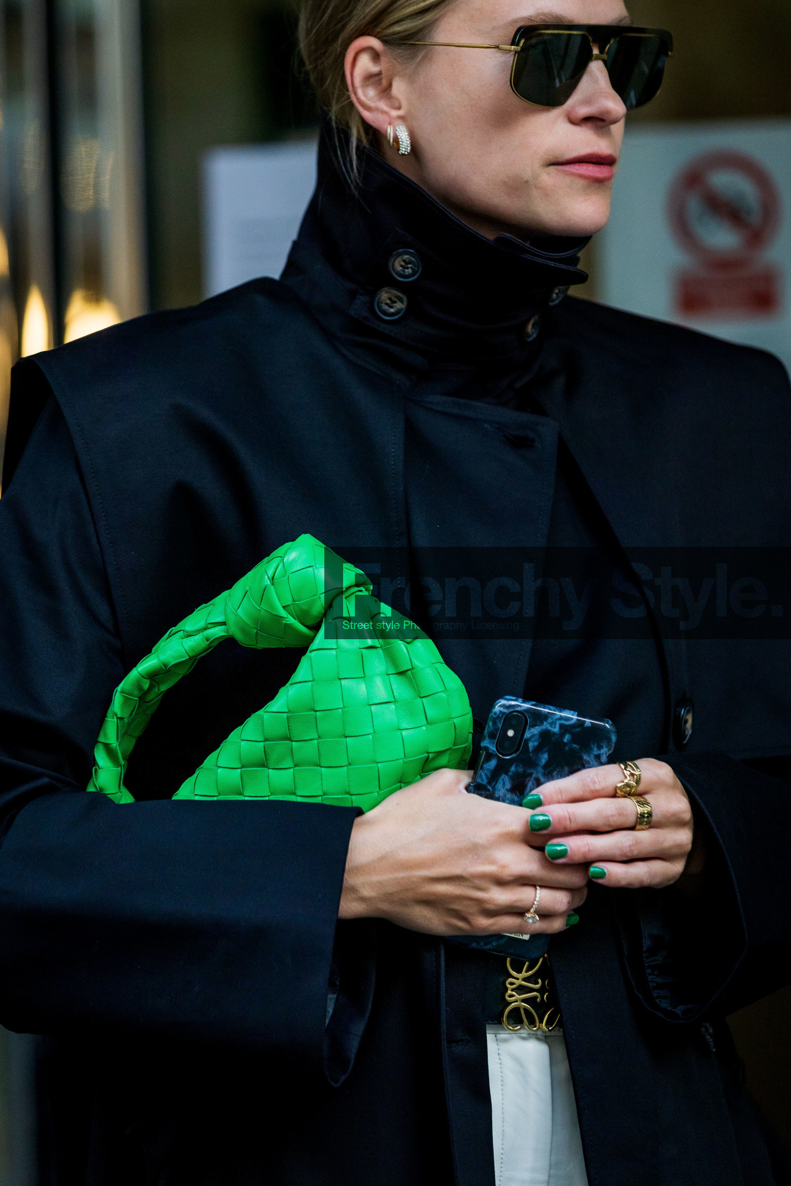 Tine Andrea Lauvli, green leather bag, green leather clutch, black trench coat, black sunglasses, aviator sunglasses, golden frame sunglasses, golden earrings, round shape earrings, round earrings, multi earrings, diamond earrings, overshirt jacket, oversize shoulder, oversize trench coat, close up detail, bag detail, bottega veneta bag, plaited leather bag, fashion week, frenchystyle, FW, jonathan paciullo, street style, SPRING SUMMER 2022, SS 22, COPENHAGEN, CPHFW, vertical, atmosphere details