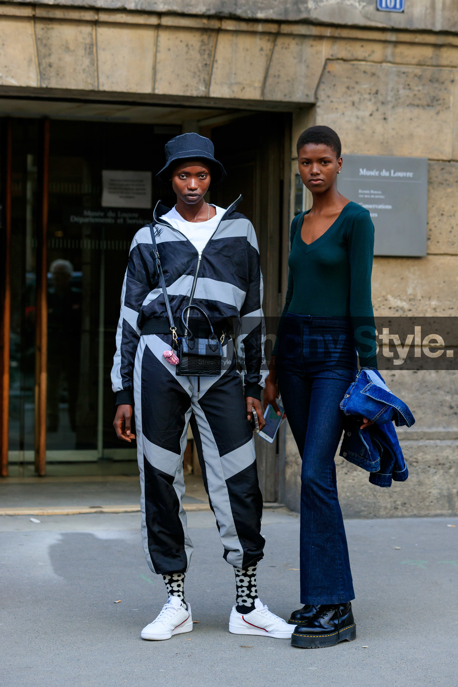 model, jogging pants, sportswear, sportswear jacket, zipped jacket, dark grey jacket, dark grey pants, light grey jacket, light grey pants, striped jacket, striped pants, black hat, black leather bag, crossbody bag, animal skin bag, mini bag, white t-shirt, airpod, airpod box, adidas sneakers, white leather sneakers, black socks, floral printed socks, dark green top, long sleeves top, low necked top, blue jeans, denim, denim jacket, flare jeans, black leather boots, doc marteens shoes, laced boots, platform shoes, PARIS, PFW, SPRING SUMMER 2020, SS 20, fashion week, frenchystyle, FW, jonathan paciullo, street style, vertical, full length