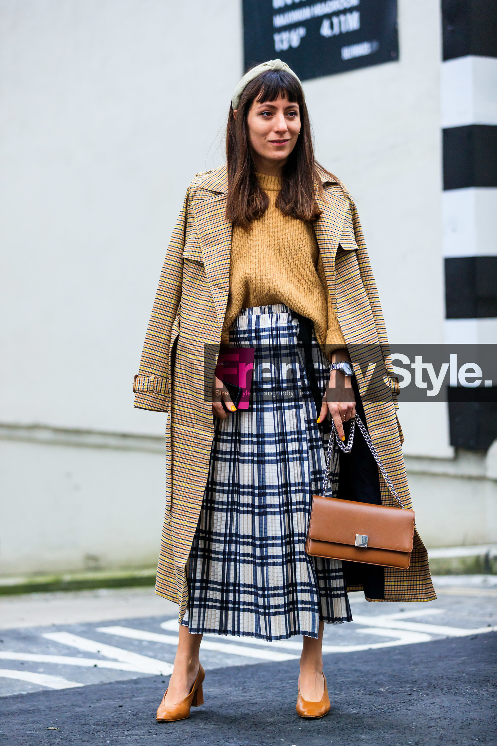 beige coat, brown coat, camel bag, camel shoes, camel sweater, checked, graphic jacket, graphic skirt, headband, high heels, leather bag, leather shoes, over the shoulder, plaid, pleated skirt, printed jacket, printed skirt, tartan, trench coat, tucked in, white skirt, LONDON, LFW, fashion week, frenchystyle, FW, jonathan paciullo, street style, AUTUMN WINTER 2019-2020, AW 19-20, FW 19-20, FALL WINTER 2019-2020, vertical, full length