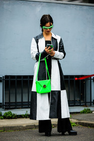fluo green sunglasses, fluo green handbag: dual toned coat, leather coat, chess motif coat, black and white coat, black platform boots, flared pants, black pants, coperni, street style, jonathan paciullo, FW, frenchystyle, fashion week, AUTUMN WINTER 2022-2023, FALL WINTER 2022_2023, FW 22-23, PFW, PARIS, full length, vertical