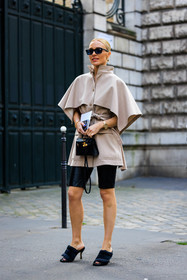 beige cape, assymetric cape, cape dress, biker short, black shorts, black sandals, heeled sandals, black sunglasses, birkin bag, mini bag, hermes bag, golden watch, street style, jonathan paciullo, FW, frenchystyle, fashion week, AUTUMN WINTER 2022-2023, FALL WINTER 2022_2023, FW 22-23, PFW, PARIS, full length, vertical