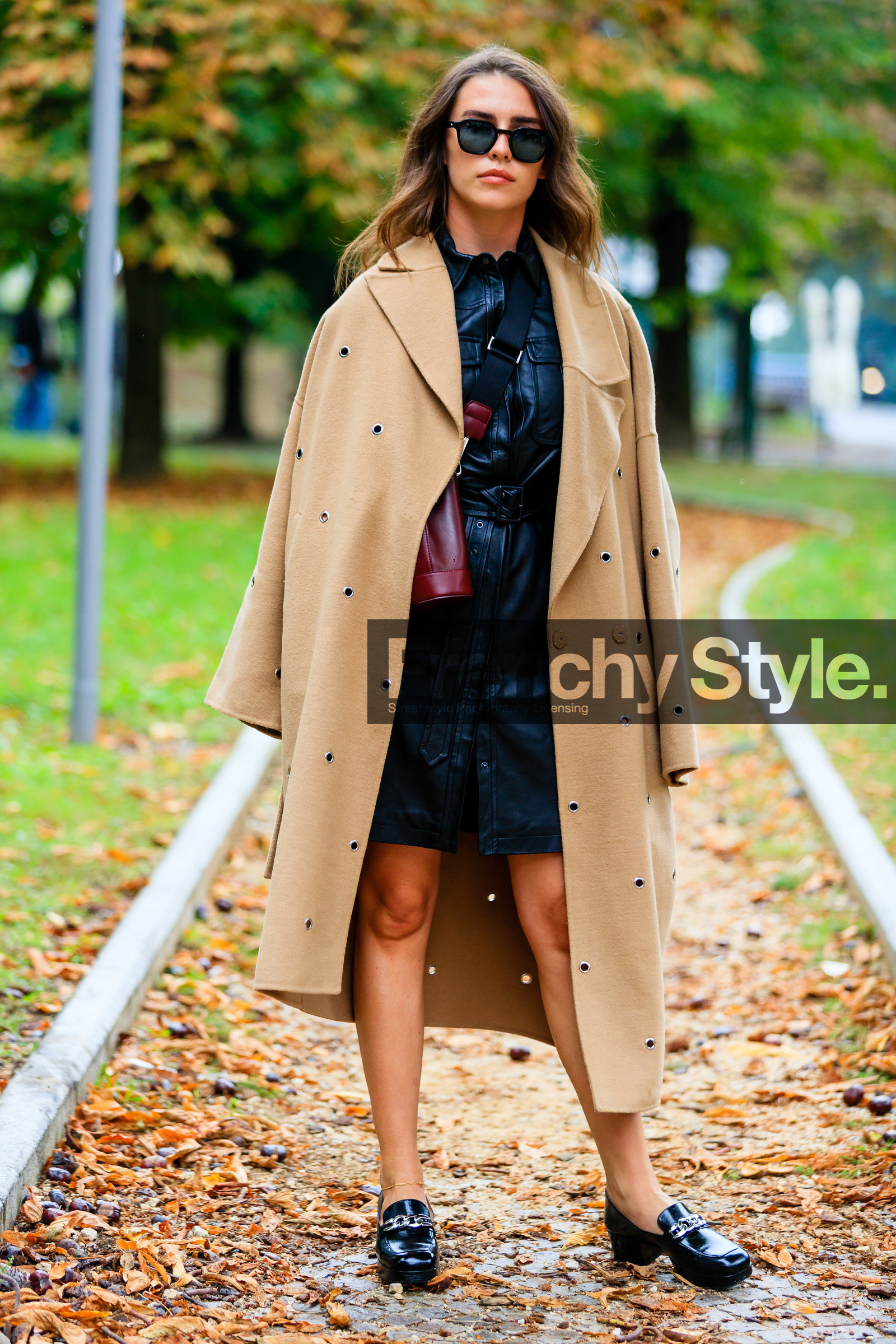 black leather dress, mini dress, button dress, belted dress, burgundy leather bag, bucket bag, crossbody bag, black sunglasses, black leather loafers, golden bracelet, ankle bracelet, camel coat, beige coat, openwork coat, studs coat, sarah lou falk, street style, jonathan paciullo, FW, frenchystyle, fashion week, MFW, MILAN, SPRING SUMMER 2021, SS 21, vertical, full length