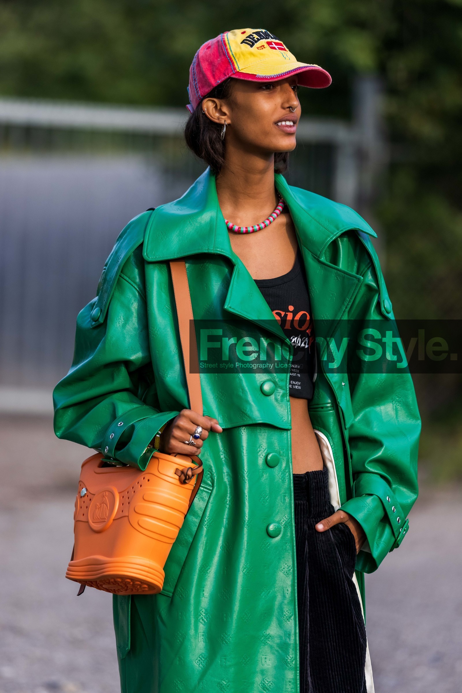bag, black crop top, black pants, cap, coat, color, corduroy pants, crop top, green coat, lanvin bag, leather coat, necklace, orange bag, printed cap, printed coat, printed crop top, red cap, yellow cap, Mona Tougaard, fashion week, frenchystyle, FW, jonathan paciullo, street style, CPHFW, COPENHAGEN, SS 22, SPRING SUMMER 2022, vertical, atmosphere details