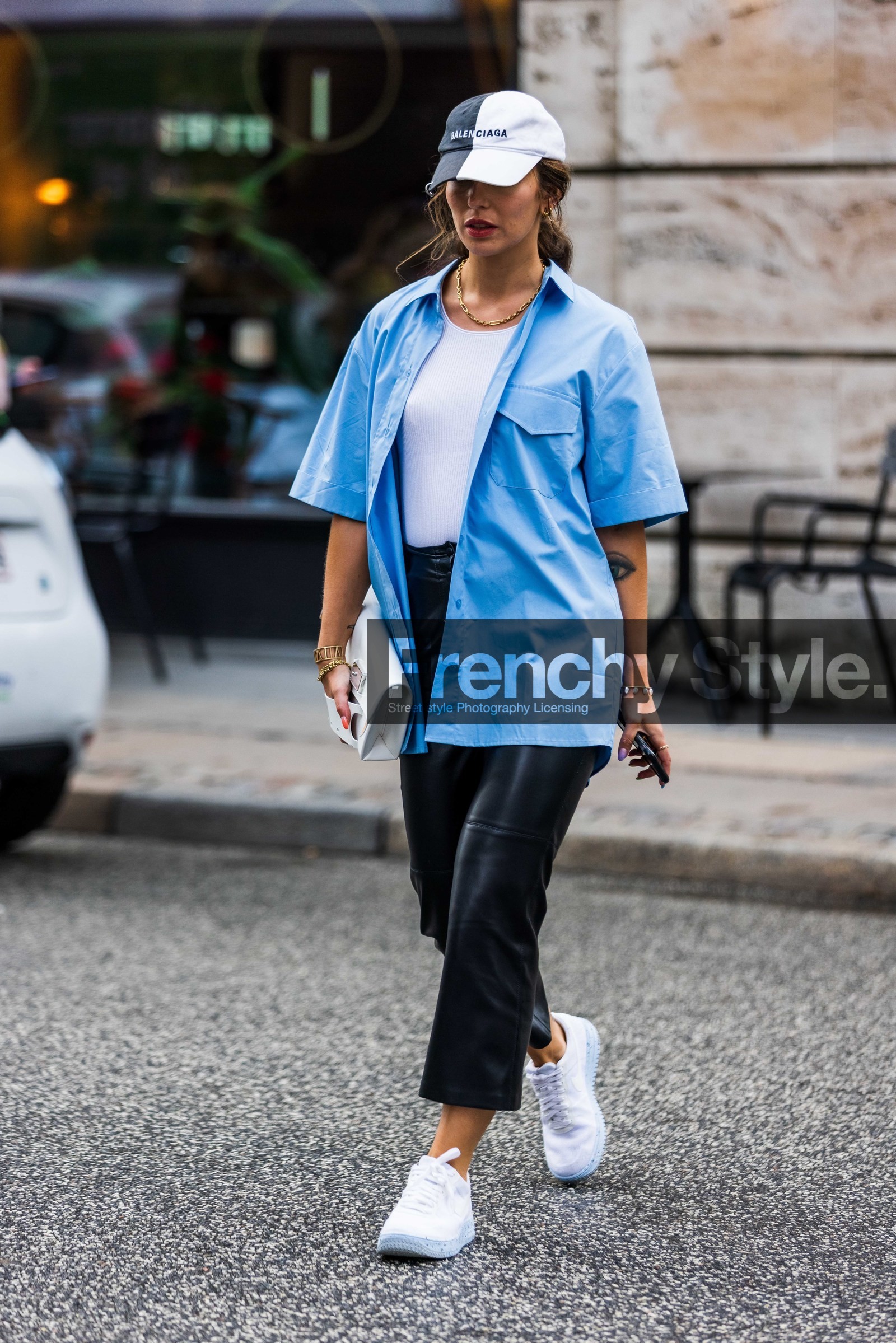 Maria Astor, light blue shirt, short sleeves shirt, white t-shirt, white cap, black cap, black leather pants, balenciaga cap, white leather clutch, margiela bag, golden bracelet, golden necklace, golden earrings, multi bracelet, multi earrings, chain necklace, nike shoes, white sneakers, cropped pants, fashion week, frenchystyle, FW, jonathan paciullo, street style, SPRING SUMMER 2022, SS 22, COPENHAGEN, CPHFW, vertical, full length