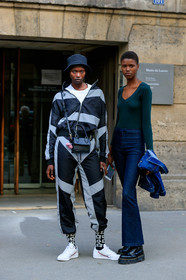 model, jogging pants, sportswear, sportswear jacket, zipped jacket, dark grey jacket, dark grey pants, light grey jacket, light grey pants, striped jacket, striped pants, black hat, black leather bag, crossbody bag, animal skin bag, mini bag, white t-shirt, airpod, airpod box, adidas sneakers, white leather sneakers, black socks, floral printed socks, dark green top, long sleeves top, low necked top, blue jeans, denim, denim jacket, flare jeans, black leather boots, doc marteens shoes, laced boots, platform shoes, PARIS, PFW, SPRING SUMMER 2020, SS 20, fashion week, frenchystyle, FW, jonathan paciullo, street style, vertical, full length