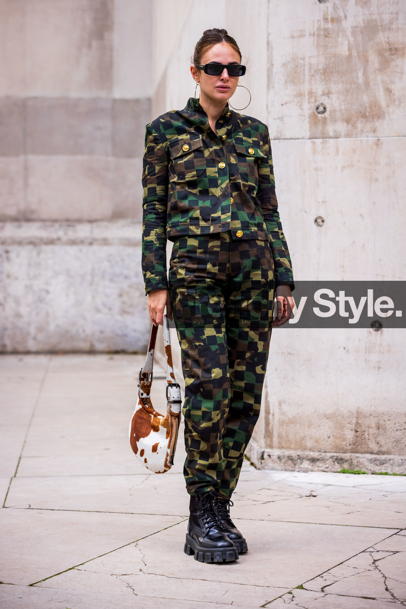 black sunglasses; camouflage print; check; jacket; khaki jacket; khaki pants; pants; printed jacket; printed pants; rectangle sunglasses; sunglasses: boots; black boots; bag; animal print; white bag; brown bag