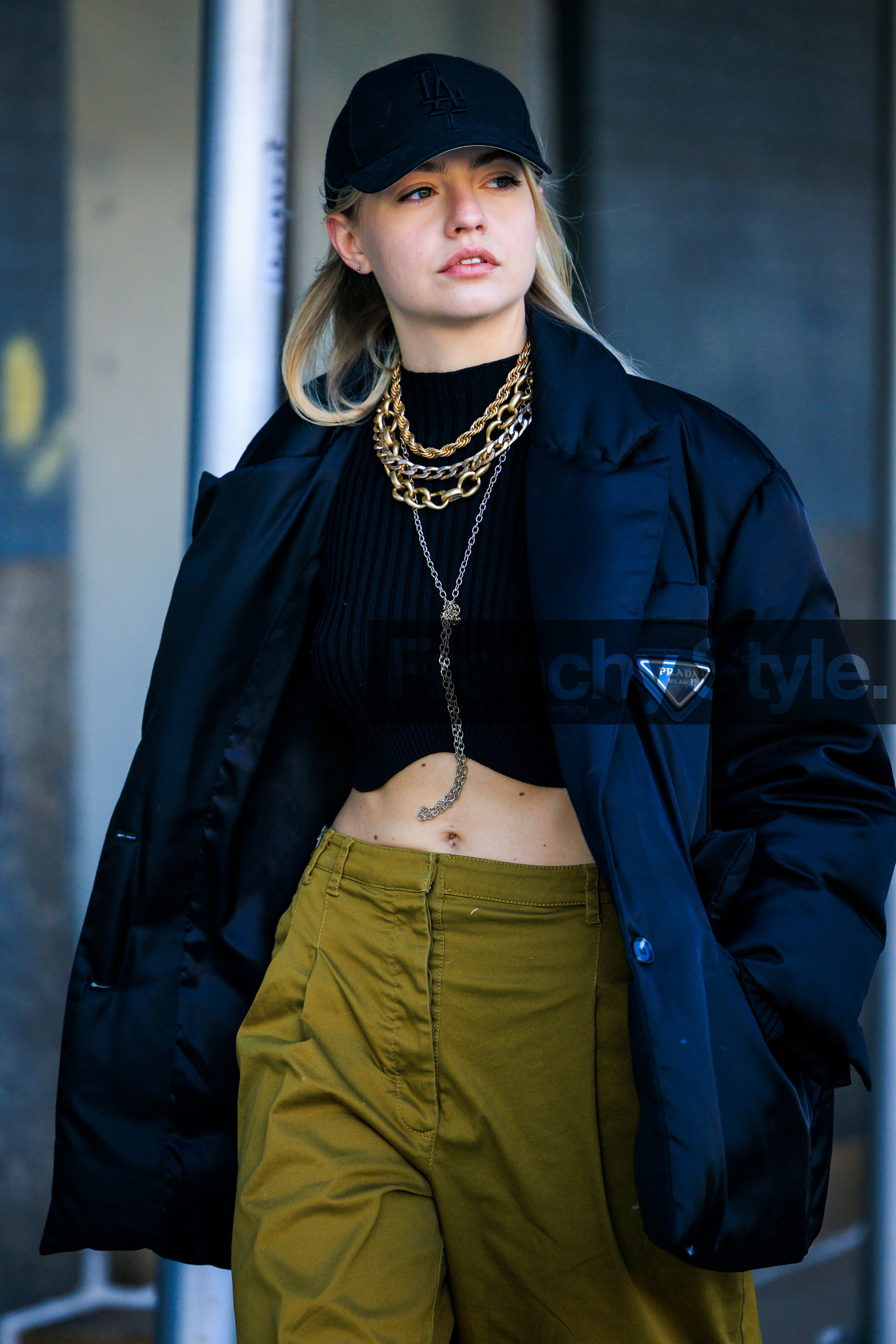 low rise pants, kaki pants, black cropped top, overlayed necklaces, golden chain necklaces, golden chains, black cap, puffy coat, black puffy blazer, prada jacket, prada blazer, puffy prada jacket, close up, fashion week, frenchystyle, FW, jonathan paciullo, street style, NYFW, NEW YORK, AUTUMN WINTER 2022-2023, FALL WINTER 2022_2023, FW 22-23, vertical, atmosphere details