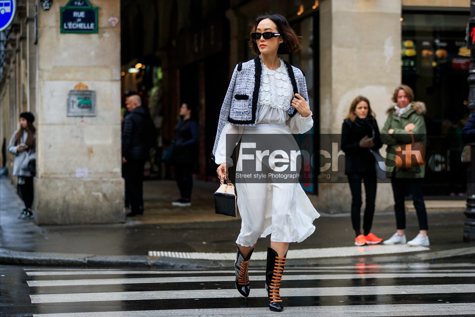 Chriselle Lim, grey jacket, tweed jacket, cropped jacket, plaited jacket, white blouse, white skirt, silk blouse, silk skirt, floral embroidered blouse, pleated skirt, mid long skirt, black polish boots, multi buckle boots, sharp end boots, high boots, camel leather boots, black sunglasses, pearl sunglasses, fashion week, frenchystyle, FW, jonathan paciullo, street style, PFW, PARIS, horizontal, atmosphere details, full length