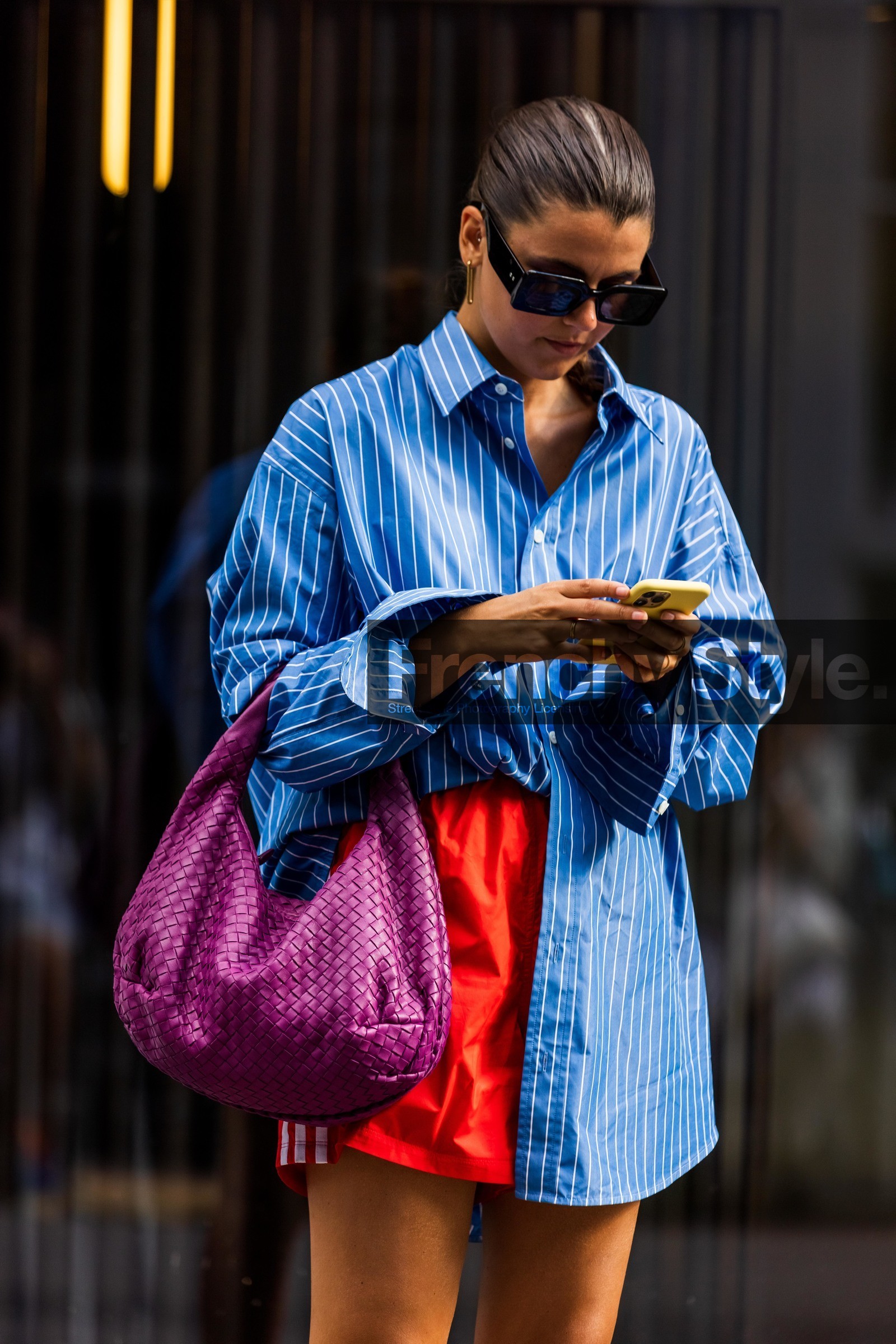 bag, black sunglasses, blue shirt, bottega veneta bag, fushia bag, leather bag, oversized shirt, pink bag, print, printed shirt, red short, shirt, short, smartphone, sport short, striped shirt, stripes, sunglasses, white lines, earrings, gold earrings, fashion week, frenchystyle, FW, jonathan paciullo, street style, SPRING SUMMER 2022, SS 22, COPENHAGEN, CPHFW, vertical, atmosphere details