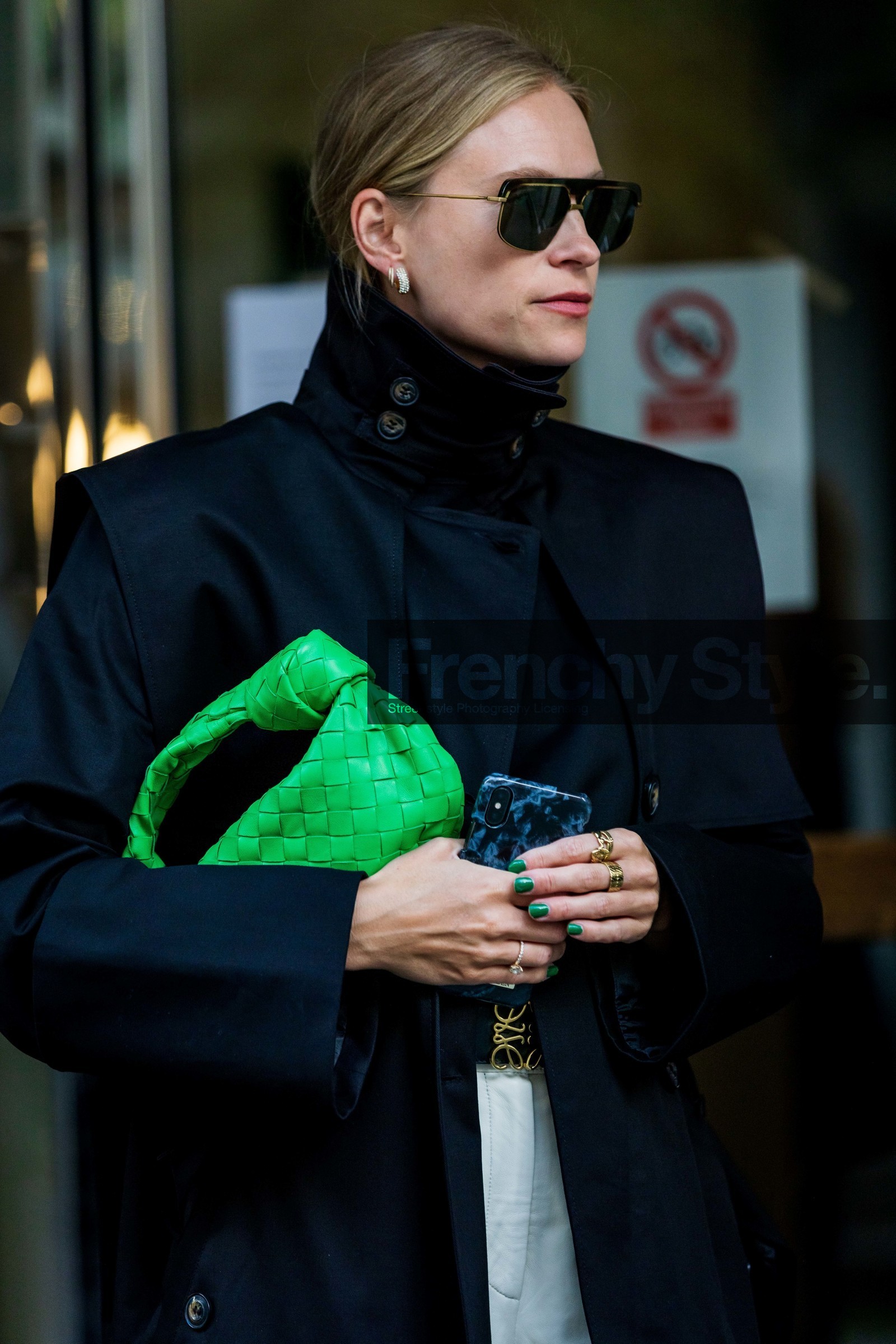 Tine Andrea Lauvli, green leather bag, green leather clutch, black trench coat, black sunglasses, aviator sunglasses, golden frame sunglasses, golden earrings, round shape earrings, round earrings, multi earrings, diamond earrings, overshirt jacket, oversize shoulder, oversize trench coat, close up detail, bag detail, bottega veneta bag, plaited leather bag, fashion week, frenchystyle, FW, jonathan paciullo, street style, SPRING SUMMER 2022, SS 22, COPENHAGEN, CPHFW, vertical, atmosphere details