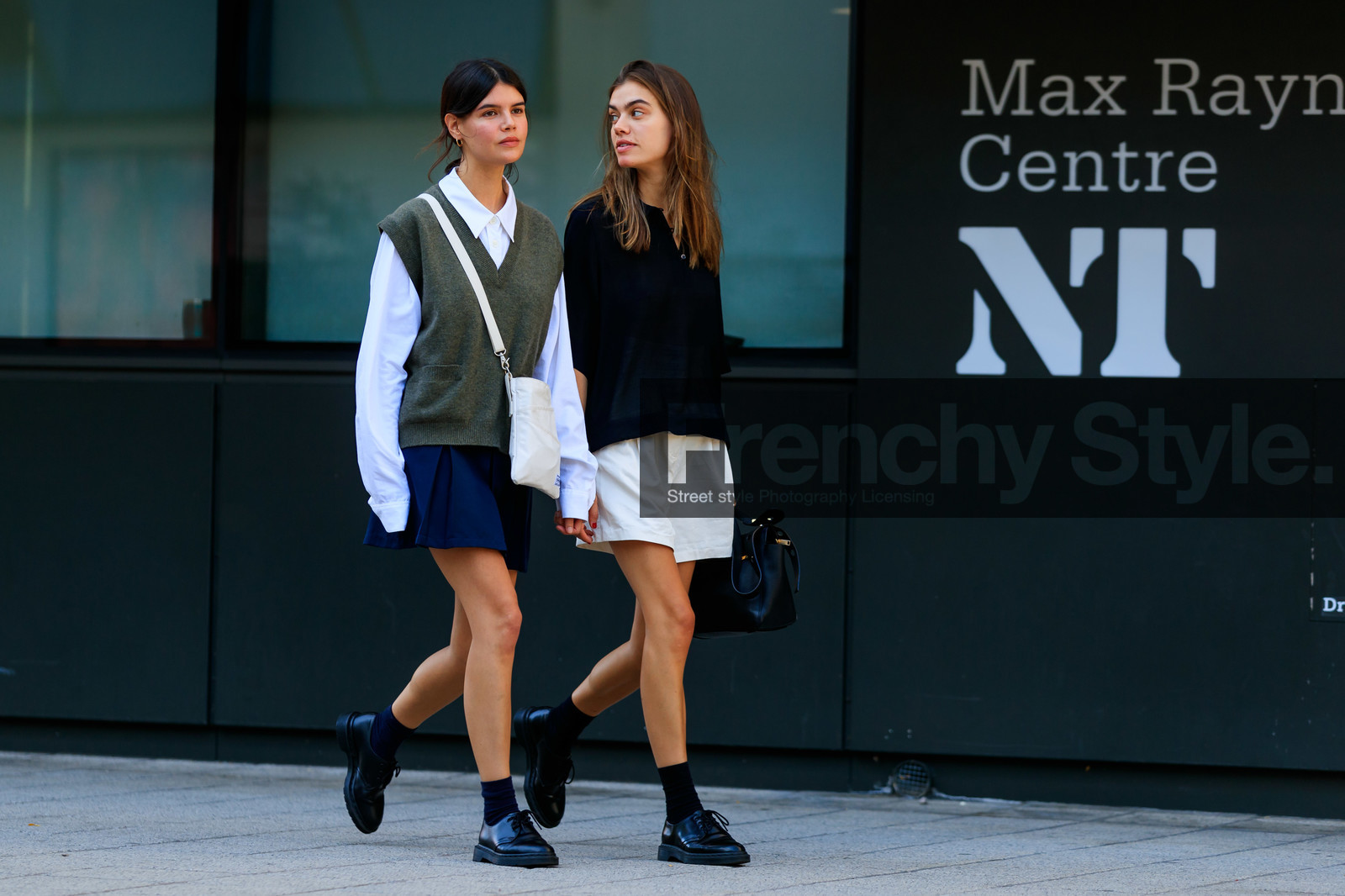 school girl look, black polo shirt, oversize polo shirt, light beige shorts, loose shorts, black leather bag, hand bag, doc marteens shoes, black leather shoes, black socks, laced shoes, high waist shorts, white shirt, oversize shirt, knitwear, sleeveless pullover, kaki pullover, man style pullover, porter bag, crossbody bag, black and white bag, square shape bag, navy blue skirt, pleated skirt, long sleeves shirt, oversize sleeves, fashion week, frenchystyle, FW, jonathan paciullo, street style, atmosphere details, horizontal, full length